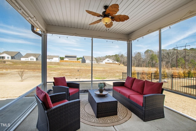 sunroom with a healthy amount of sunlight and ceiling fan