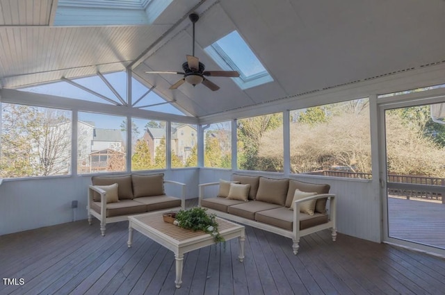 sunroom / solarium with lofted ceiling with skylight and ceiling fan