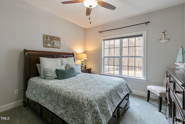 carpeted bedroom featuring baseboards and a ceiling fan