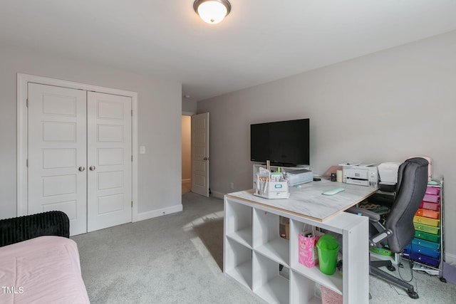 office area with light carpet and baseboards