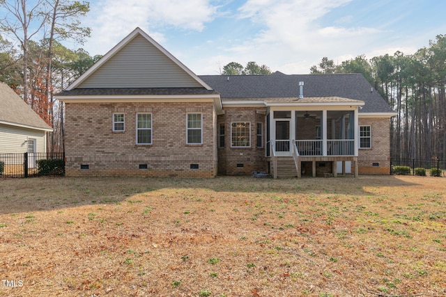 rear view of house featuring a yard, crawl space, and a sunroom