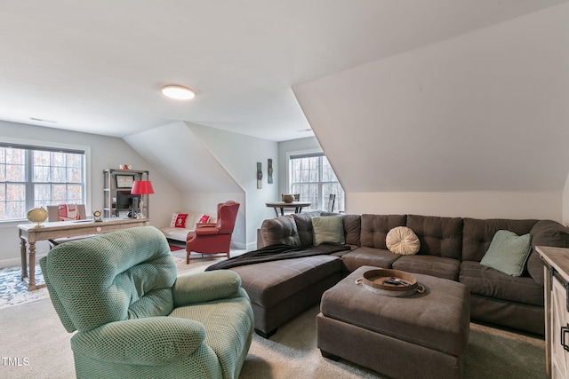 living area featuring carpet, vaulted ceiling, and baseboards