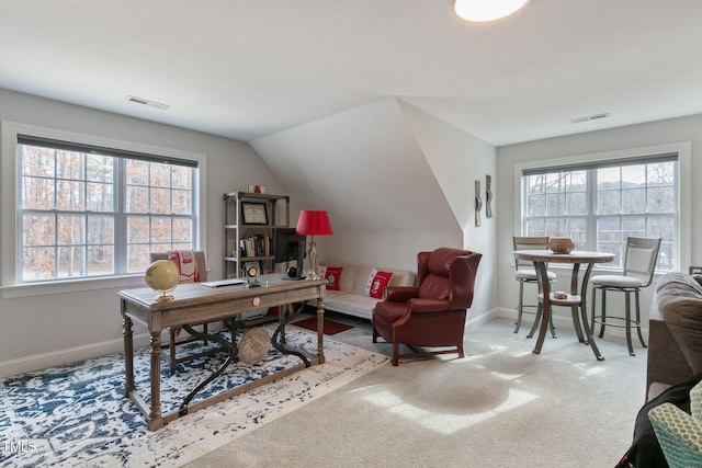 home office featuring a wealth of natural light, visible vents, lofted ceiling, and baseboards