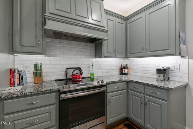 kitchen with premium range hood, tasteful backsplash, stainless steel range with electric cooktop, and gray cabinetry