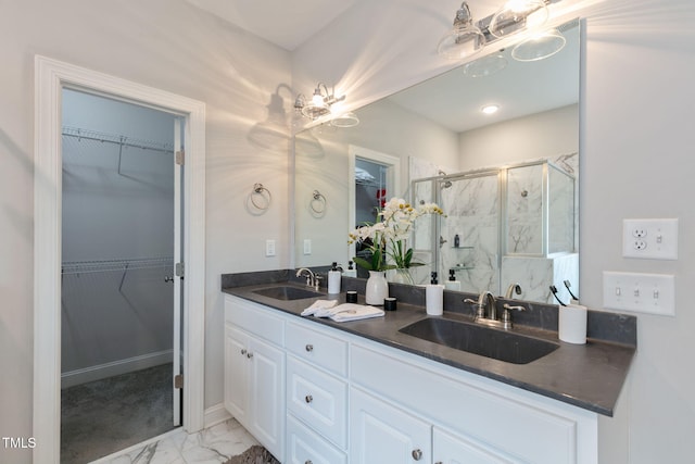 full bath featuring marble finish floor, a sink, a marble finish shower, and double vanity