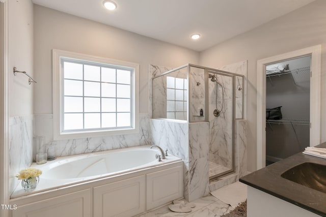 full bathroom featuring marble finish floor, a sink, a marble finish shower, and a bath