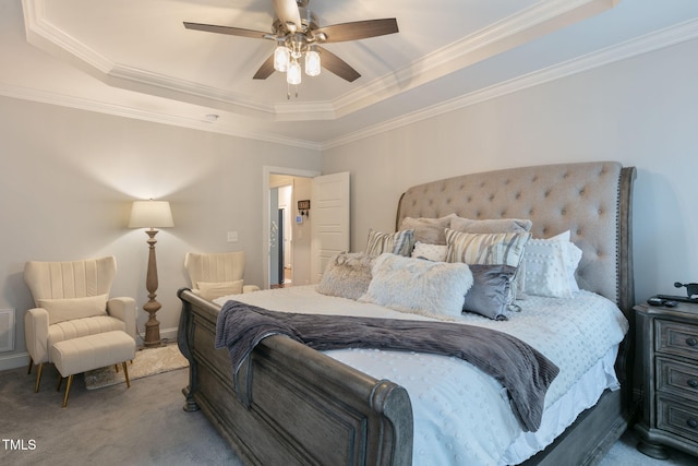 carpeted bedroom featuring a ceiling fan, a raised ceiling, visible vents, and crown molding