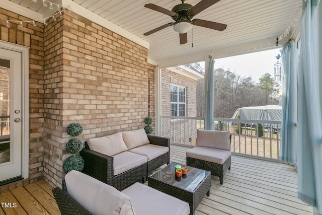 deck with an outdoor living space and a ceiling fan