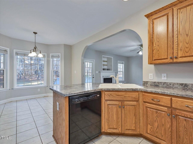 kitchen with arched walkways, brown cabinets, dishwasher, and a sink