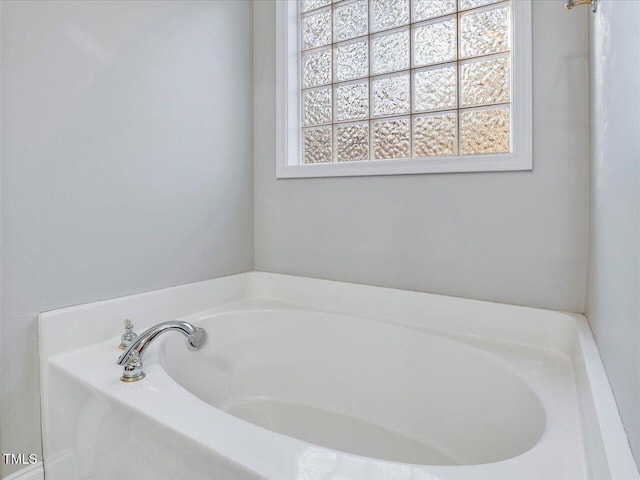 full bathroom featuring plenty of natural light and a garden tub