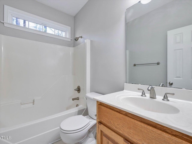 bathroom with shower / washtub combination, toilet, and vanity