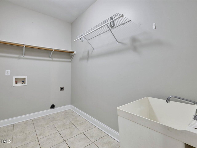 washroom featuring light tile patterned floors, laundry area, hookup for a washing machine, hookup for an electric dryer, and a sink