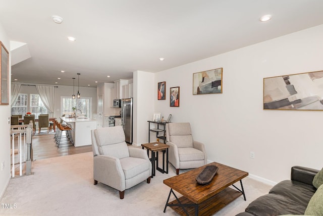 living room featuring baseboards and recessed lighting