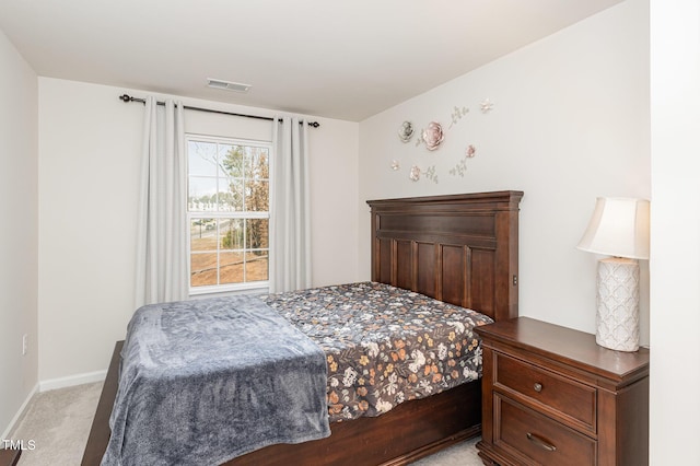 bedroom with light colored carpet, visible vents, and baseboards