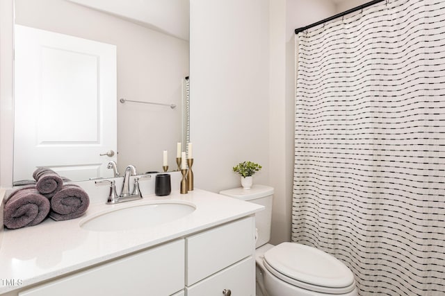 bathroom with curtained shower, vanity, and toilet