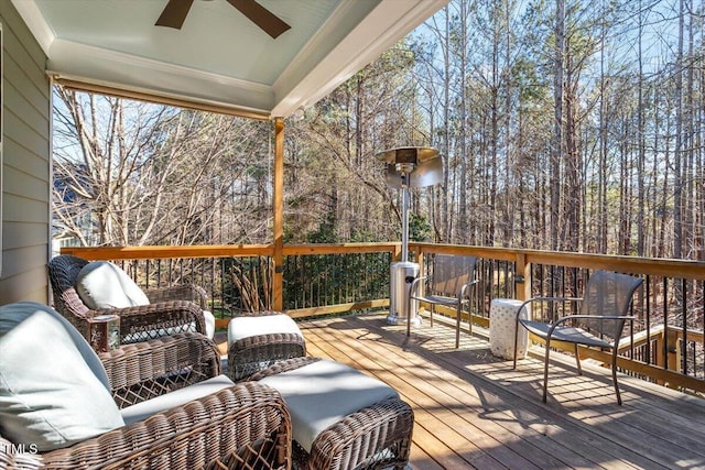 deck featuring a ceiling fan and an outdoor living space