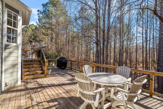 deck with outdoor dining area and area for grilling