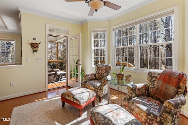 sunroom / solarium featuring a ceiling fan