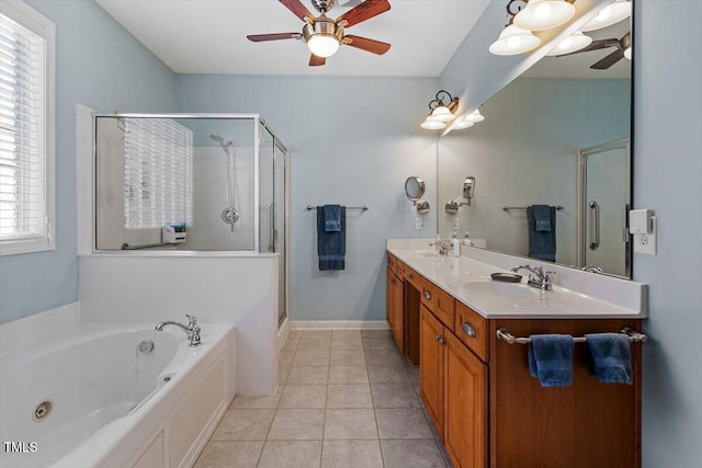 full bath featuring double vanity, a shower stall, a ceiling fan, and a sink