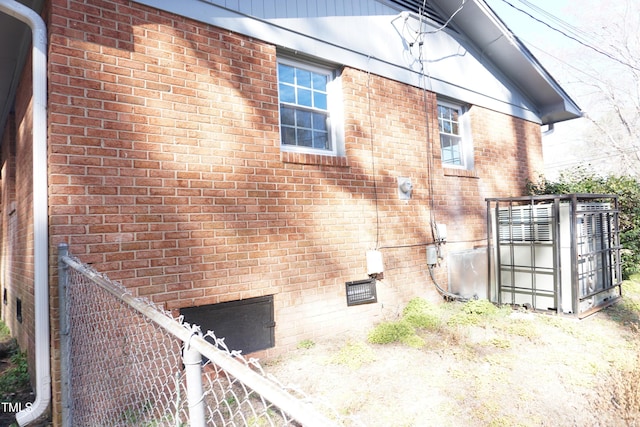 view of property exterior with brick siding and crawl space