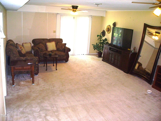 living area featuring carpet floors and a ceiling fan