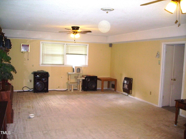 miscellaneous room featuring ceiling fan, carpet flooring, and heating unit