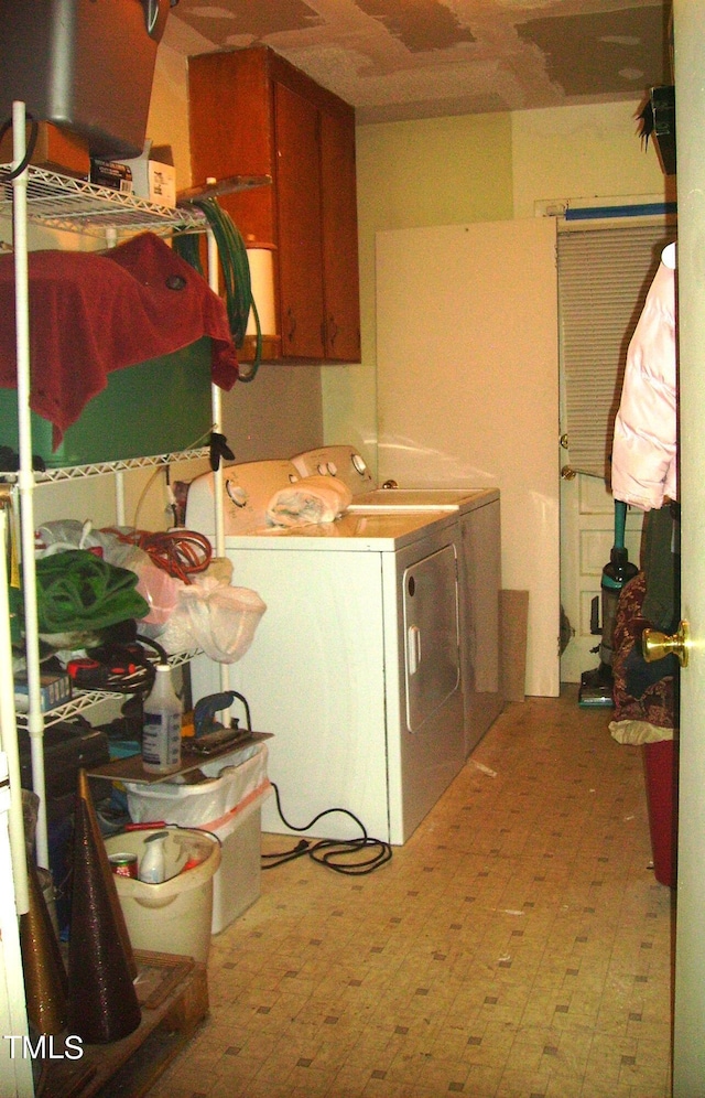 washroom featuring cabinet space, separate washer and dryer, and tile patterned floors