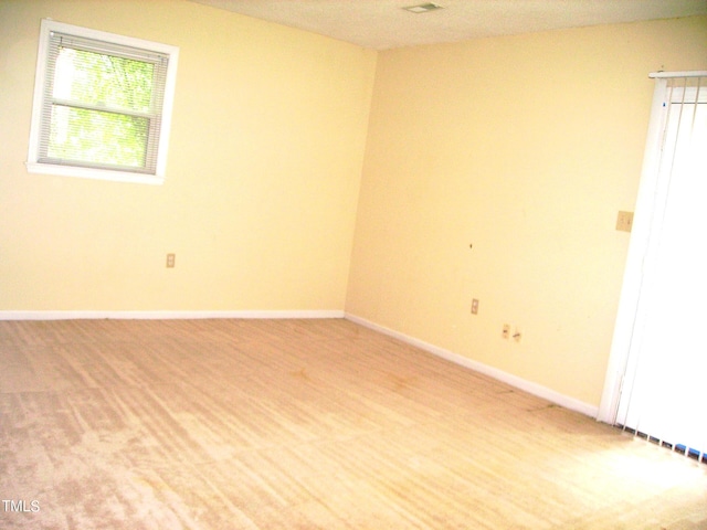 spare room featuring baseboards