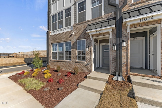 entrance to property with brick siding