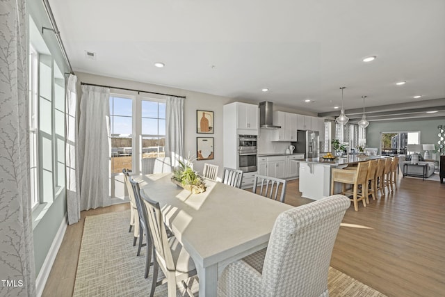 dining area featuring light wood-style floors, visible vents, baseboards, and recessed lighting