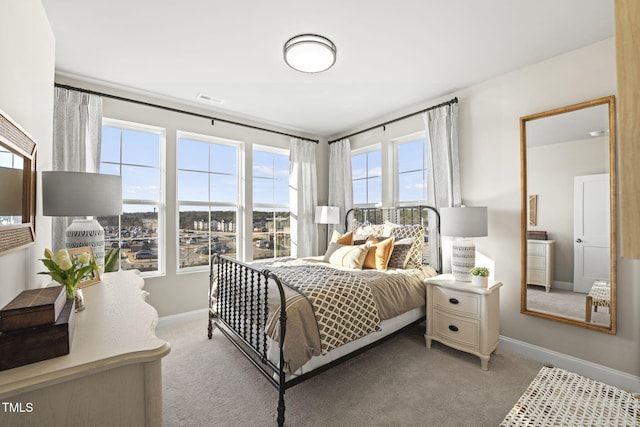 bedroom featuring baseboards, visible vents, and light colored carpet