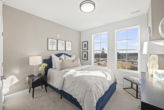 bedroom featuring baseboards, visible vents, and carpet flooring