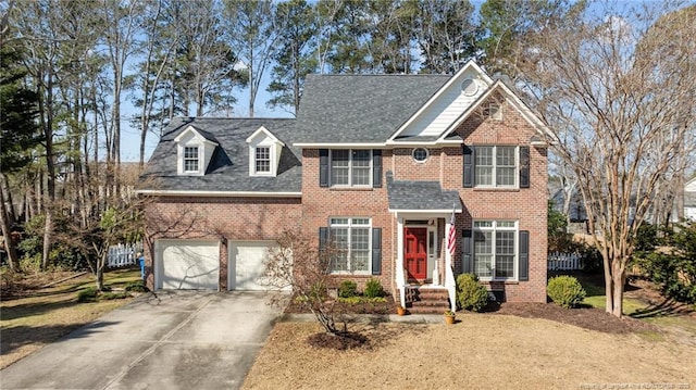 view of front facade with a garage, concrete driveway, brick siding, and roof with shingles