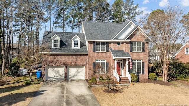 view of front of home featuring driveway, a garage, and brick siding