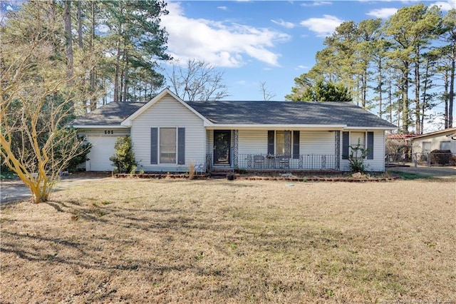 single story home with an attached garage, a porch, and a front yard