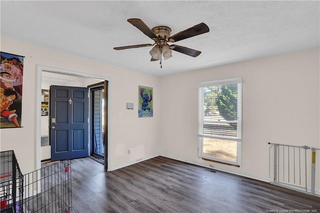 entrance foyer featuring radiator heating unit, dark wood finished floors, baseboards, and ceiling fan