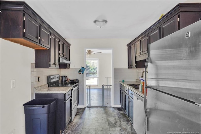 kitchen featuring stainless steel appliances, light countertops, backsplash, a sink, and under cabinet range hood