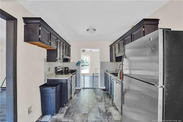 kitchen with stainless steel appliances, light countertops, backsplash, and a ceiling fan