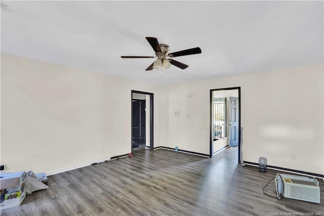 unfurnished room featuring baseboards and wood finished floors