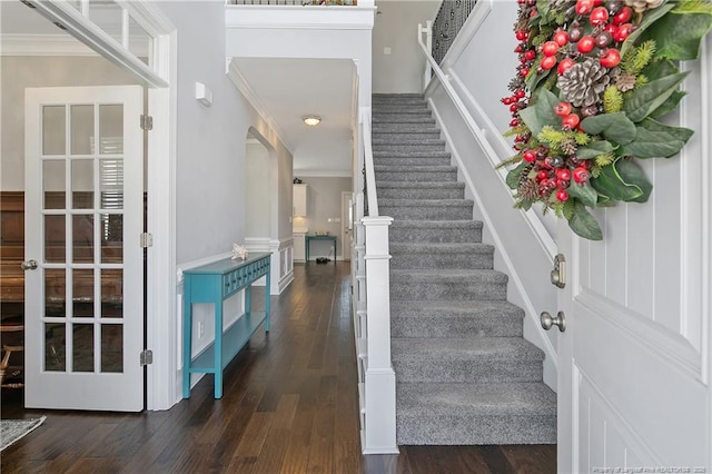 entryway with ornamental molding, dark wood-style flooring, and stairway