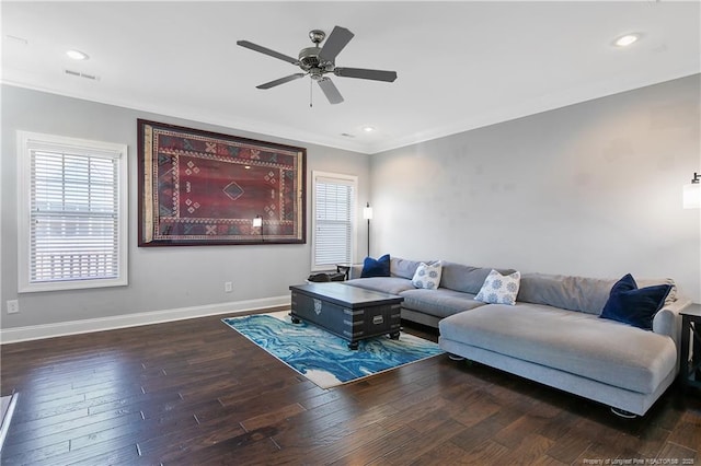 living area featuring baseboards, a wealth of natural light, and wood finished floors