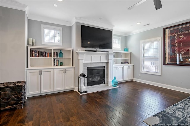 living area with a fireplace, plenty of natural light, and dark wood finished floors