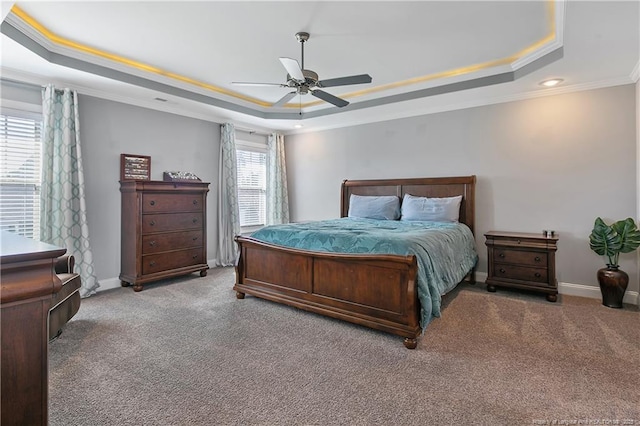 bedroom featuring carpet floors, a raised ceiling, and baseboards