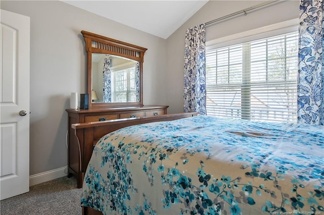 carpeted bedroom with baseboards and vaulted ceiling