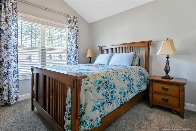 carpeted bedroom with multiple windows, vaulted ceiling, and baseboards