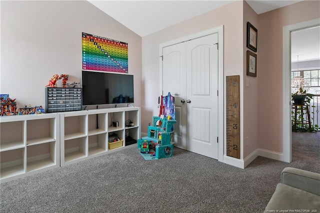 playroom with carpet, lofted ceiling, and baseboards