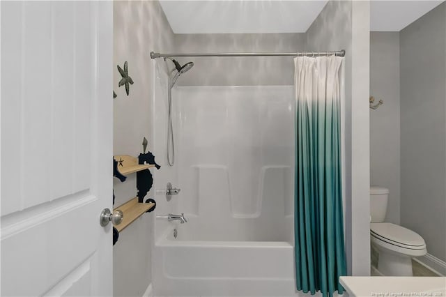 bathroom featuring shower / tub combo and toilet