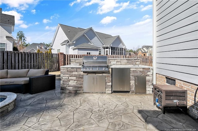 view of patio / terrace with a residential view, a fenced backyard, grilling area, and area for grilling