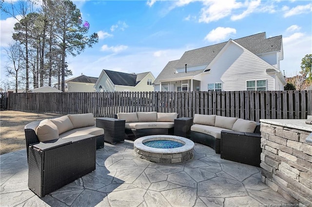 view of patio with a fenced backyard and an outdoor living space with a fire pit