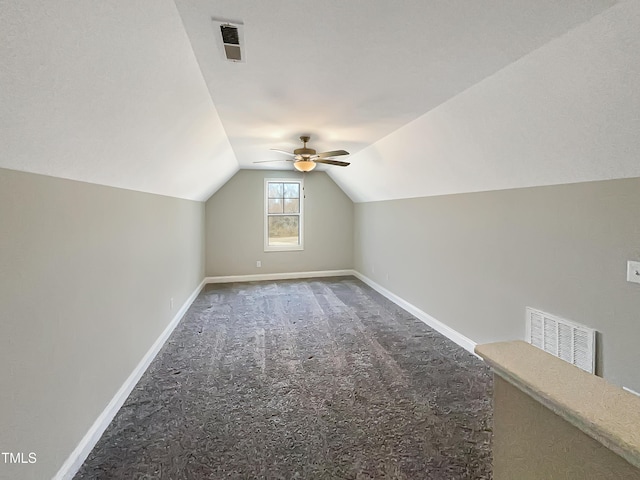 additional living space with lofted ceiling, carpet flooring, visible vents, and baseboards